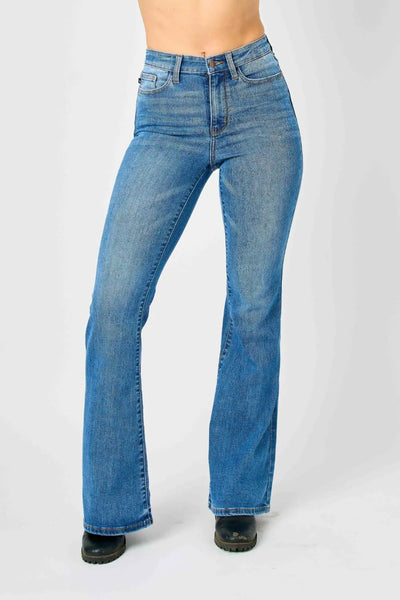 Side view of the model showcasing the fit of Judy Blue high-waisted flare jeans.