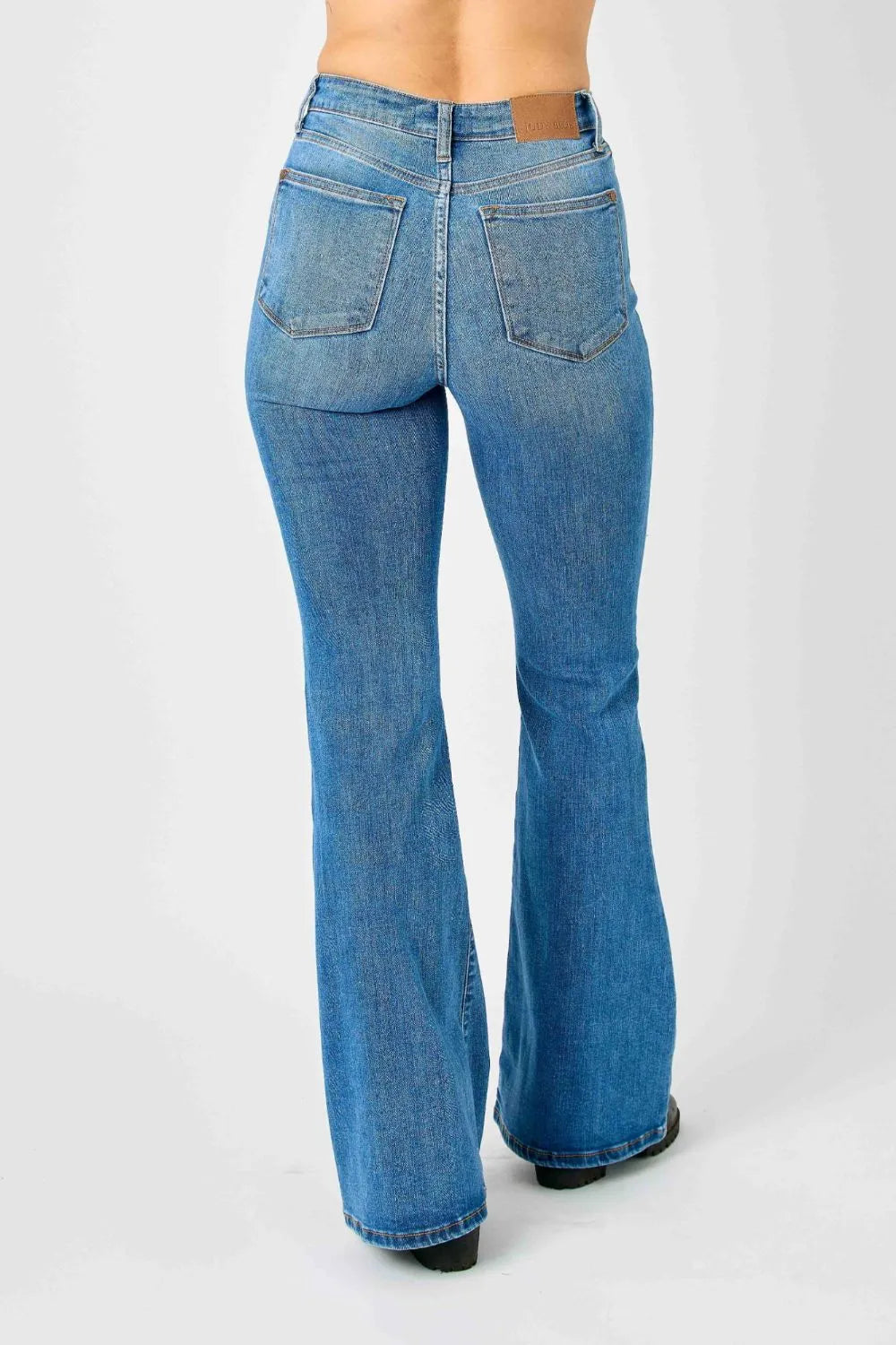 Close-up of the stitching and fabric texture of Judy Blue high-waisted flare jeans in a light wash.