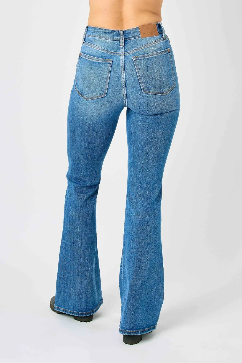Model showing the relaxed fit of the full-length Judy Blue high-waisted flare jeans, with a slightly bootcut silhouette.
