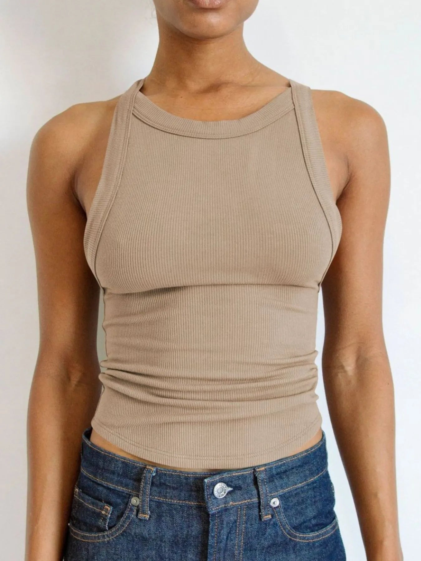 Light beige asymmetrical back ribbed crop tank top for women, featuring ribbed texture and fitted silhouette, perfect for casual summer outfits or layering