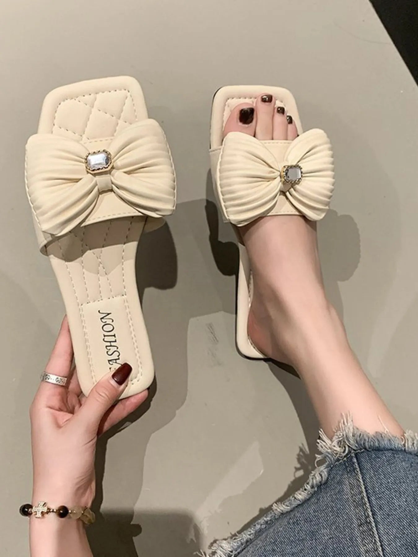 "Back view of model wearing Bow Knot Flat Sandals, showing the simple yet stylish design.