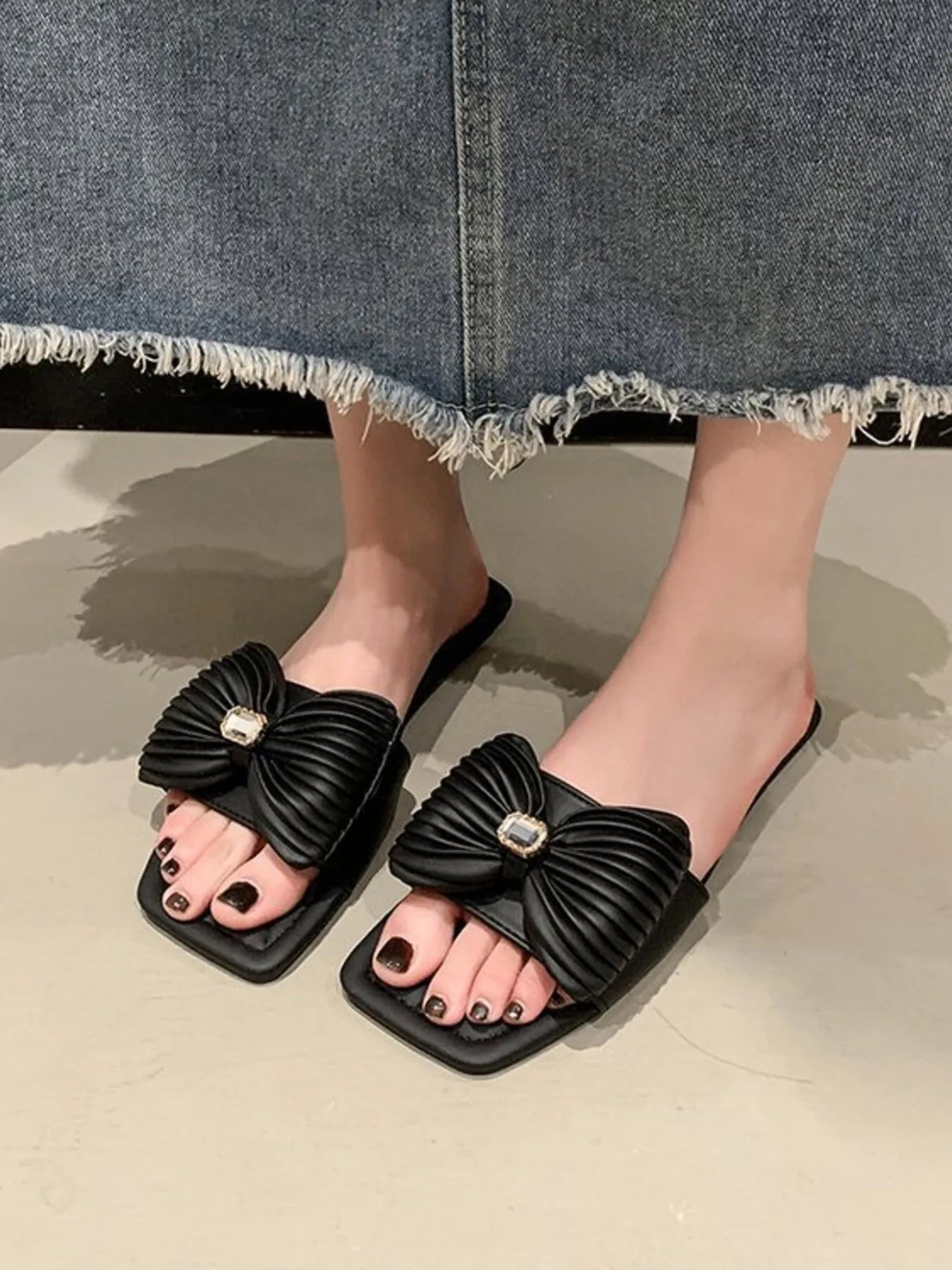 Model wearing Bow Knot Flat Sandals, showcasing the chic and comfortable design with a bow accent.