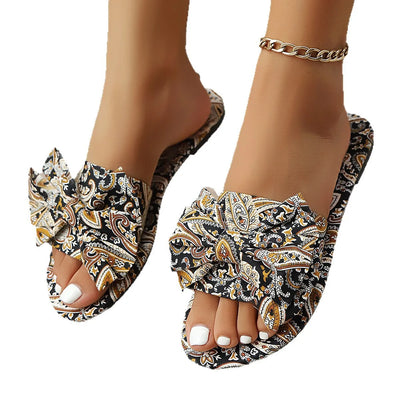 Close-up of black and multicolor bow printed open-toe sandals for women, featuring a stylish bow detail and vibrant design, perfect for casual summer outfits