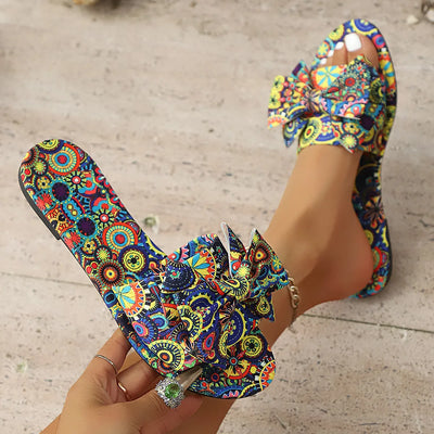 Side view of multicolor floral bow printed open-toe sandals for women, showcasing vibrant floral patterns and a stylish bow detail – perfect for casual summer wear