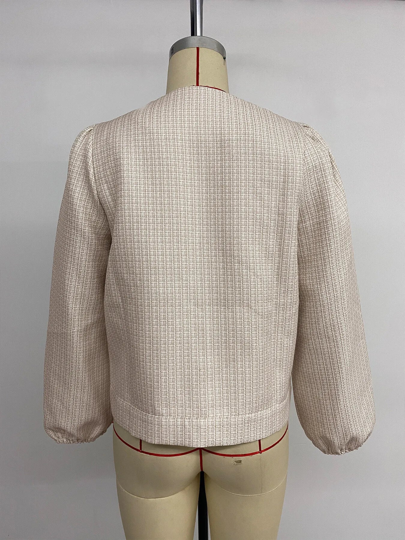 Angled back view of Button Front Jacket with Pocket Details on model, emphasizing fabric texture and fit.