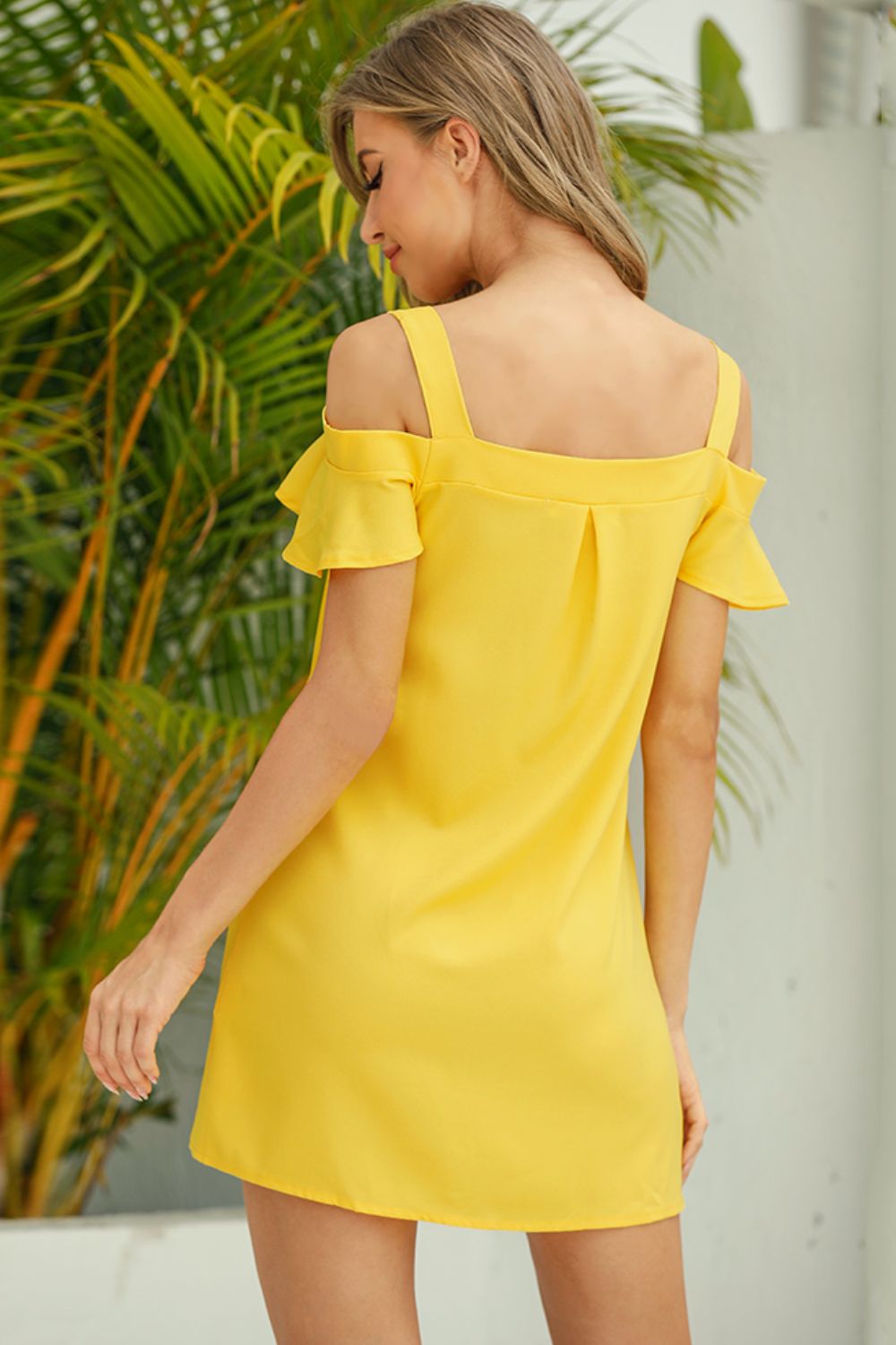 Side view of Cold Shoulder Mini Dress, showcasing the cold shoulder cutouts and fitted silhouette.