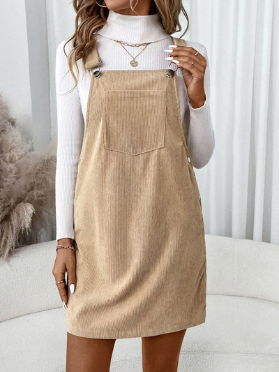 Front view of Corduroy Overall Dress with Pocket in brown, featuring adjustable straps and large front pocket.
