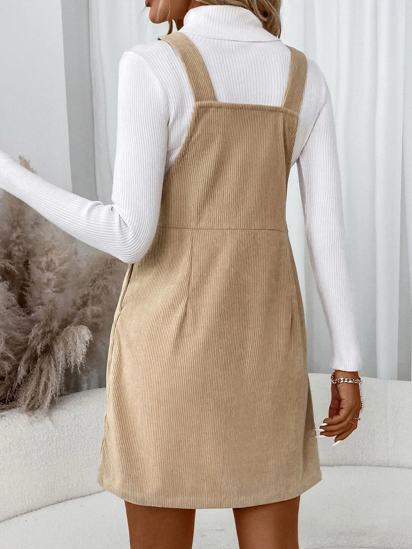 Close-up of the front and straps of Corduroy Overall Dress, showcasing fabric texture and adjustable straps.