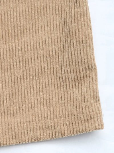 Angled full-body view of model wearing Corduroy Overall Dress with Pocket, showing the overall fit and styling.