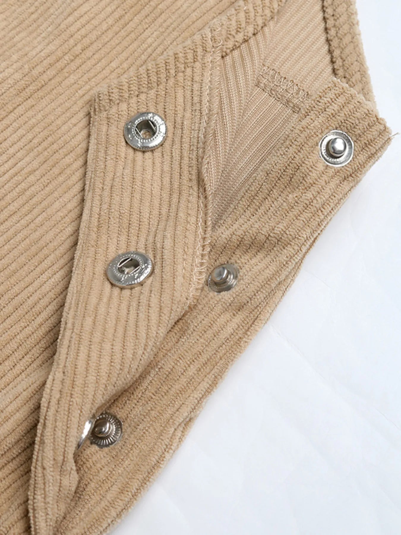 Side view of model wearing Corduroy Overall Dress with Pocket, highlighting the relaxed fit and adjustable straps.