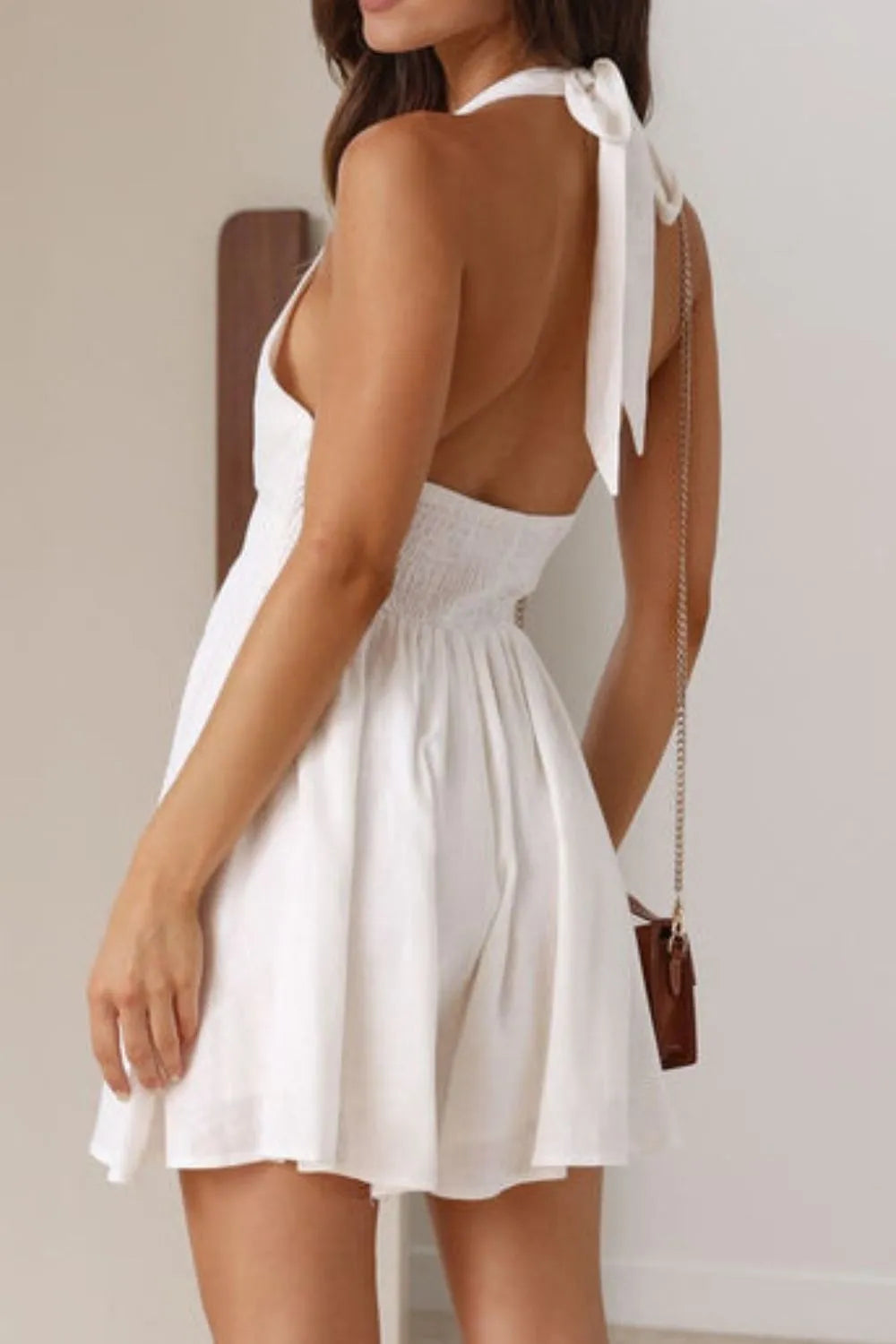 Close-up side view of Cutout Halter Neck Mini Dress, highlighting cutout detail and fitted silhouette.