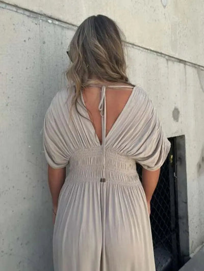 Angled back view of Full Size Deep V-Neck Maxi Dress with Side Slit, showing back fit and flowing silhouette.