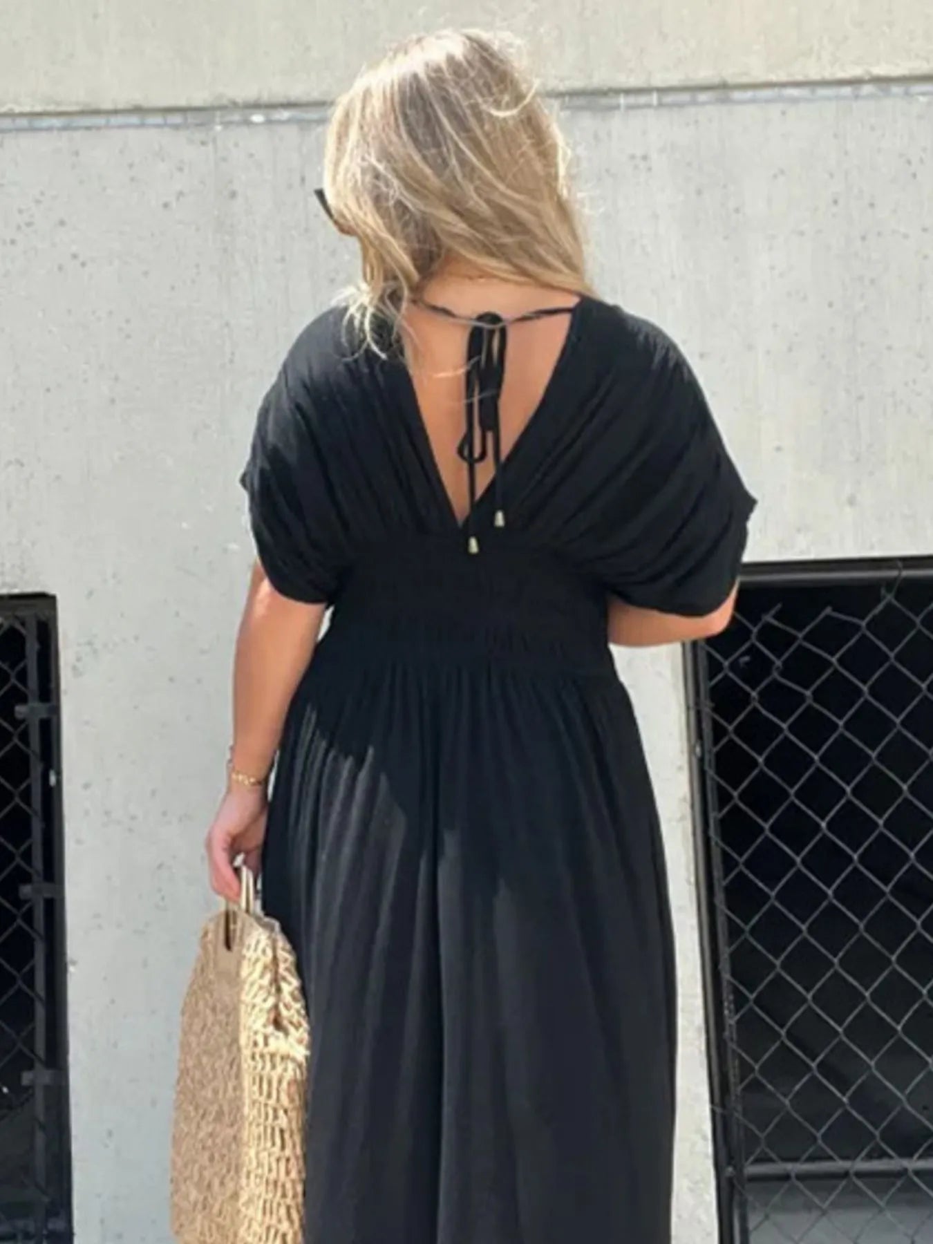 Back view of Full Size Deep V-Neck Maxi Dress with Side Slit, highlighting the open back design and floor-length style.