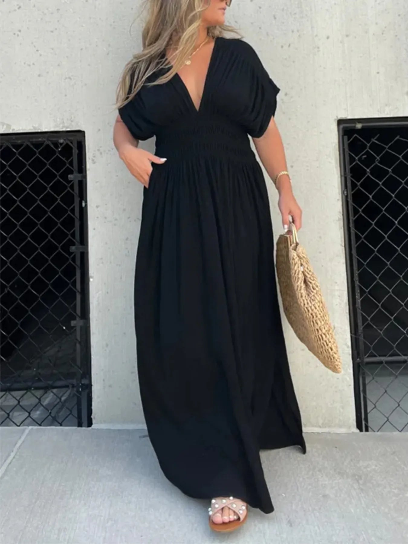 Side view of Full Size Deep V-Neck Maxi Dress with Side Slit, showing the slit and flowing fabric for a flattering silhouette.
