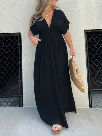 Side view of Full Size Deep V-Neck Maxi Dress with Side Slit, showing the slit and flowing fabric for a flattering silhouette.