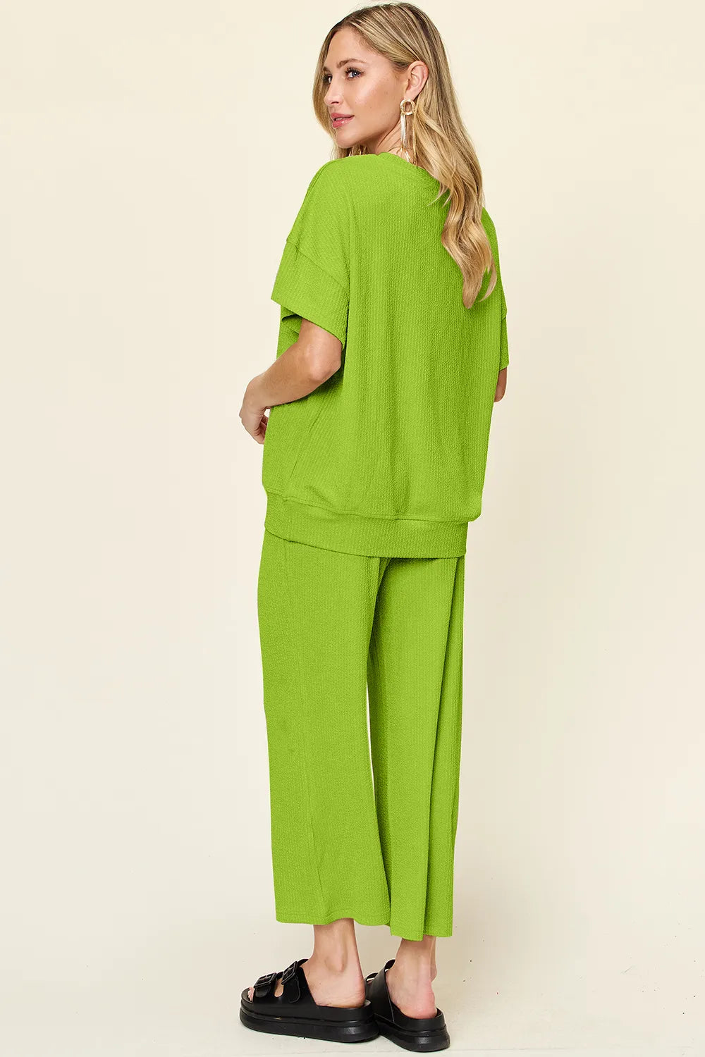 Back view of Double Take Texture Round Neck T-Shirt and Wide Leg Pants, showing full coverage and comfortable fit.