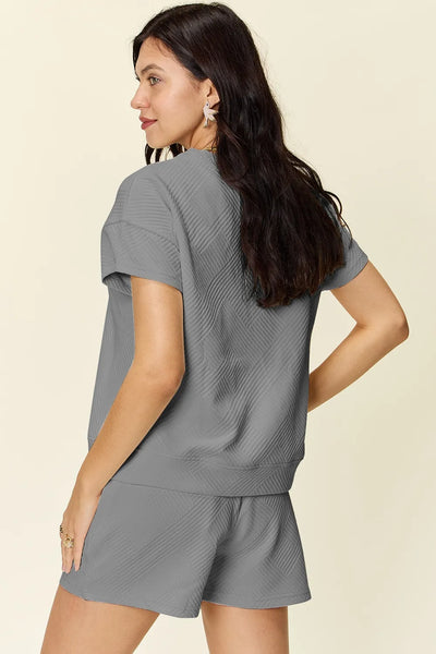 Model back view wearing Double Take Texture T-Shirt and Shorts Set, highlighting relaxed fit and overall look.
