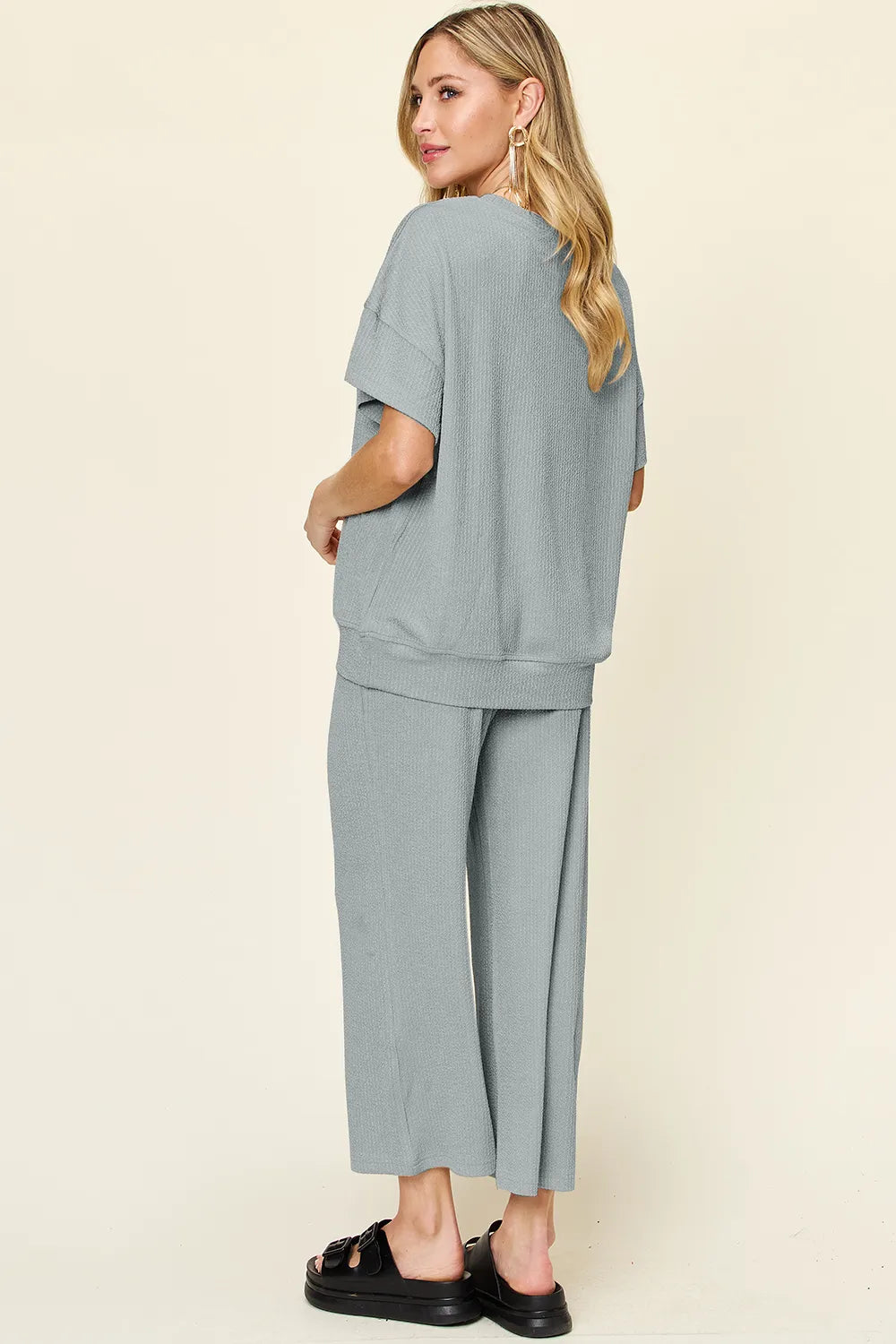 Angled front view of Double Take Texture Set on model, showing T-shirt and pants relaxed fit.