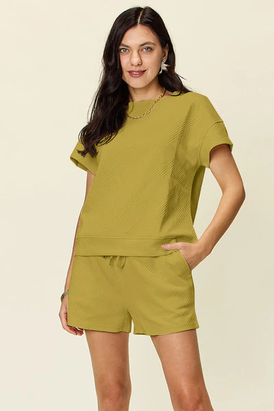 Full-body angled view of model wearing Double Take Texture Set, showing T-shirt and shorts styling.