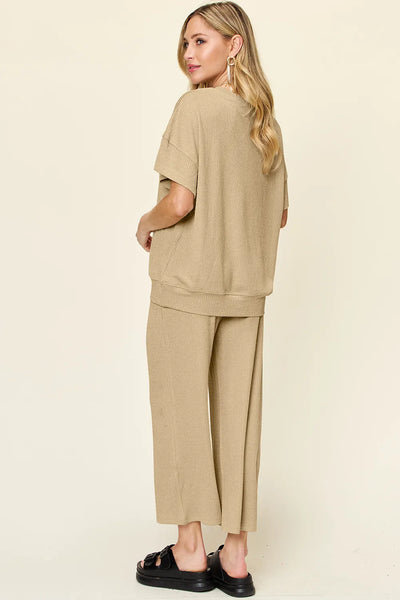 Angled full-body view of model wearing Double Take Texture T-Shirt and Wide Leg Pants, showing overall fit and outfit styling.
