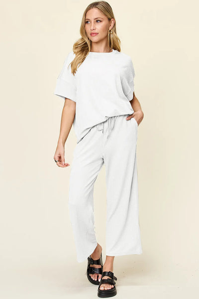 Front view of wide-leg pants on model, highlighting flowy design and waistband in Double Take Texture Set.