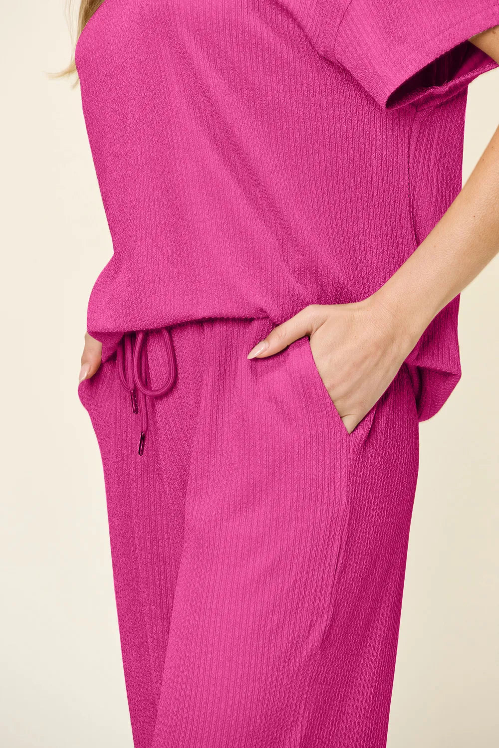 "Close-up of pants hem in Double Take Texture Set, showing clean stitching and wide-leg design.