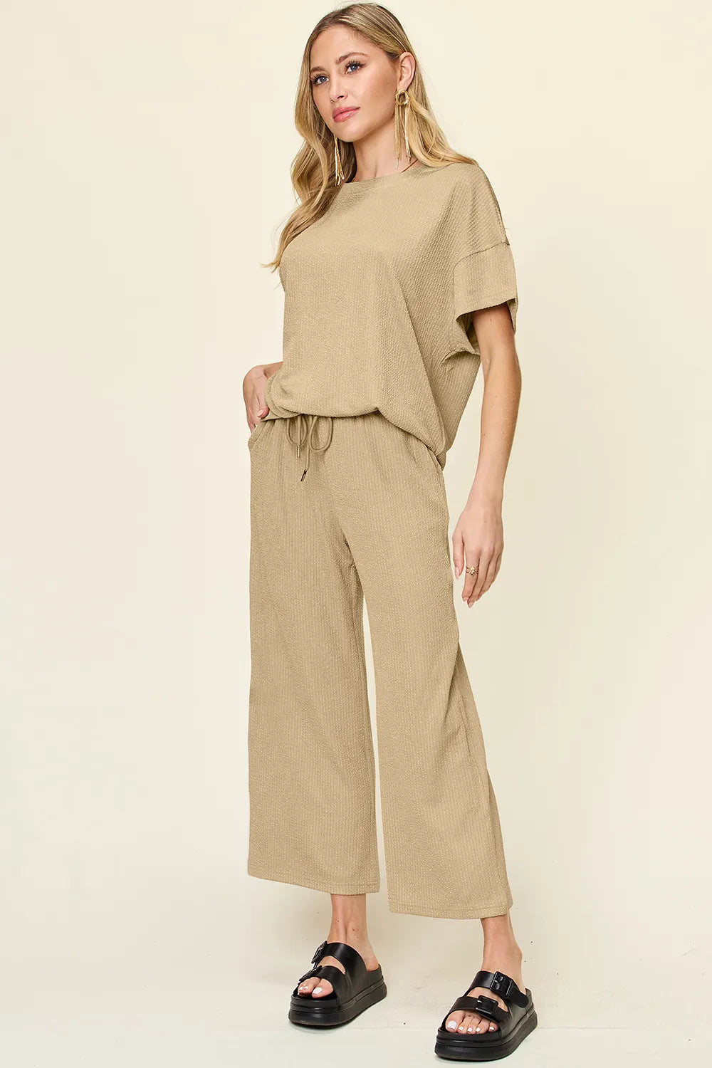 Side angle view of wide-leg pants in Double Take Texture Set, highlighting flowy silhouette and waistband.
