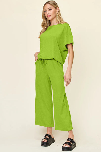 Side view of Double Take Texture Round Neck T-Shirt and Wide Leg Pants, highlighting wide-leg pants and relaxed silhouette.