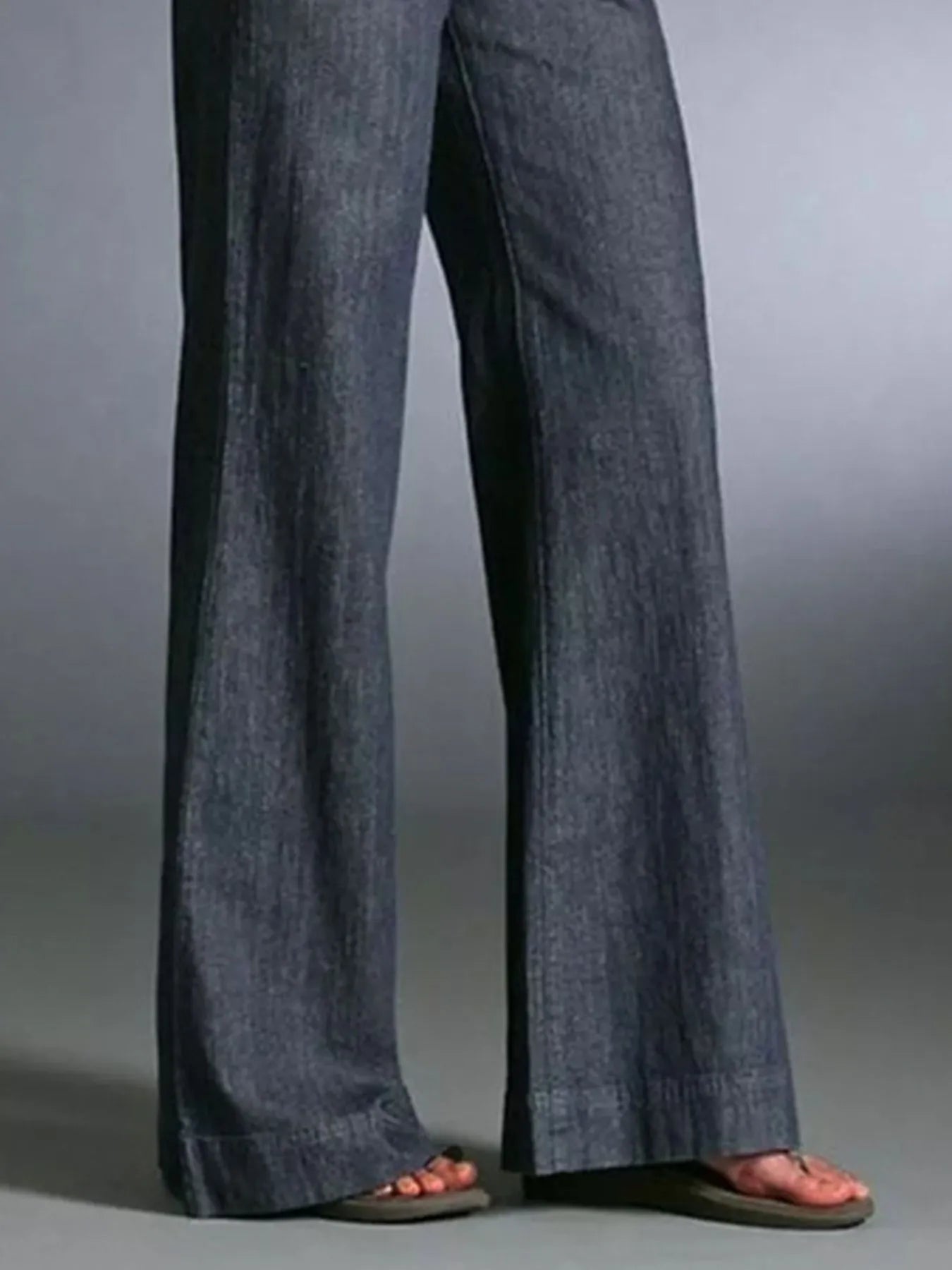 Close-up of the fabric texture and hem details of Full Size High-Waisted Wide Leg Wash Jeans, emphasizing the quality and style.