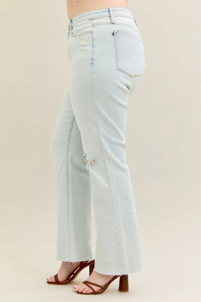 Plus-size model wearing Judy Blue Full Size Destroy Fray Hem Bootcut Jeans, showing the flattering bootcut fit and distressed details.