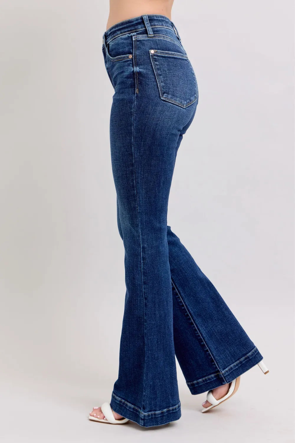 Model posing confidently in Judy Blue High-Rise Flare Jeans with pockets, highlighting the trendy fit and classic design.