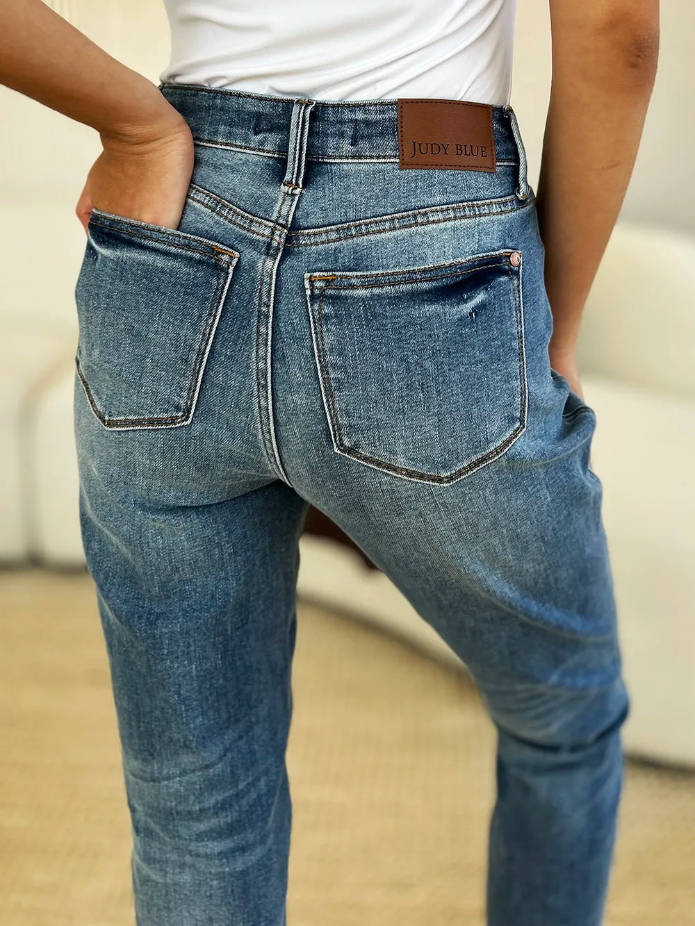 Close-up of the front detailing of Judy Blue Full Size Mid Rise Rigid Magic Release Hem Jeans.