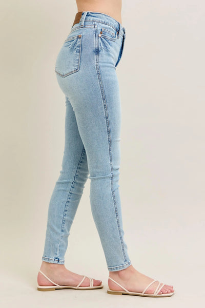 Side view showcasing the fit of Judy Blue Full Size Mid Rise Tummy Control Vintage Wash Skinny Jeans Plus Size.