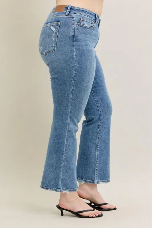 Styled front view of Judy Blue Full Size Mid Rise Wash Destroy Hem Bootcut Jeans Plus Size with accessories.
