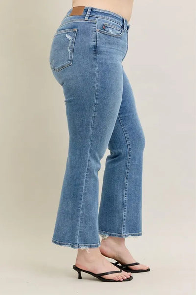 Styled front view of Judy Blue Full Size Mid Rise Wash Destroy Hem Bootcut Jeans Plus Size with accessories.