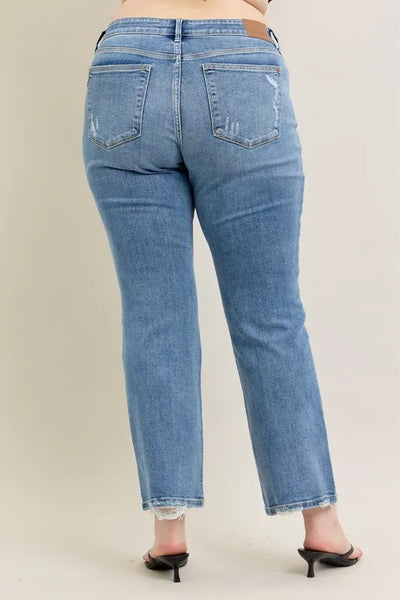 Styled side view of Judy Blue Full Size Mid Rise Wash Destroy Hem Bootcut Jeans Plus Size, paired with a top.