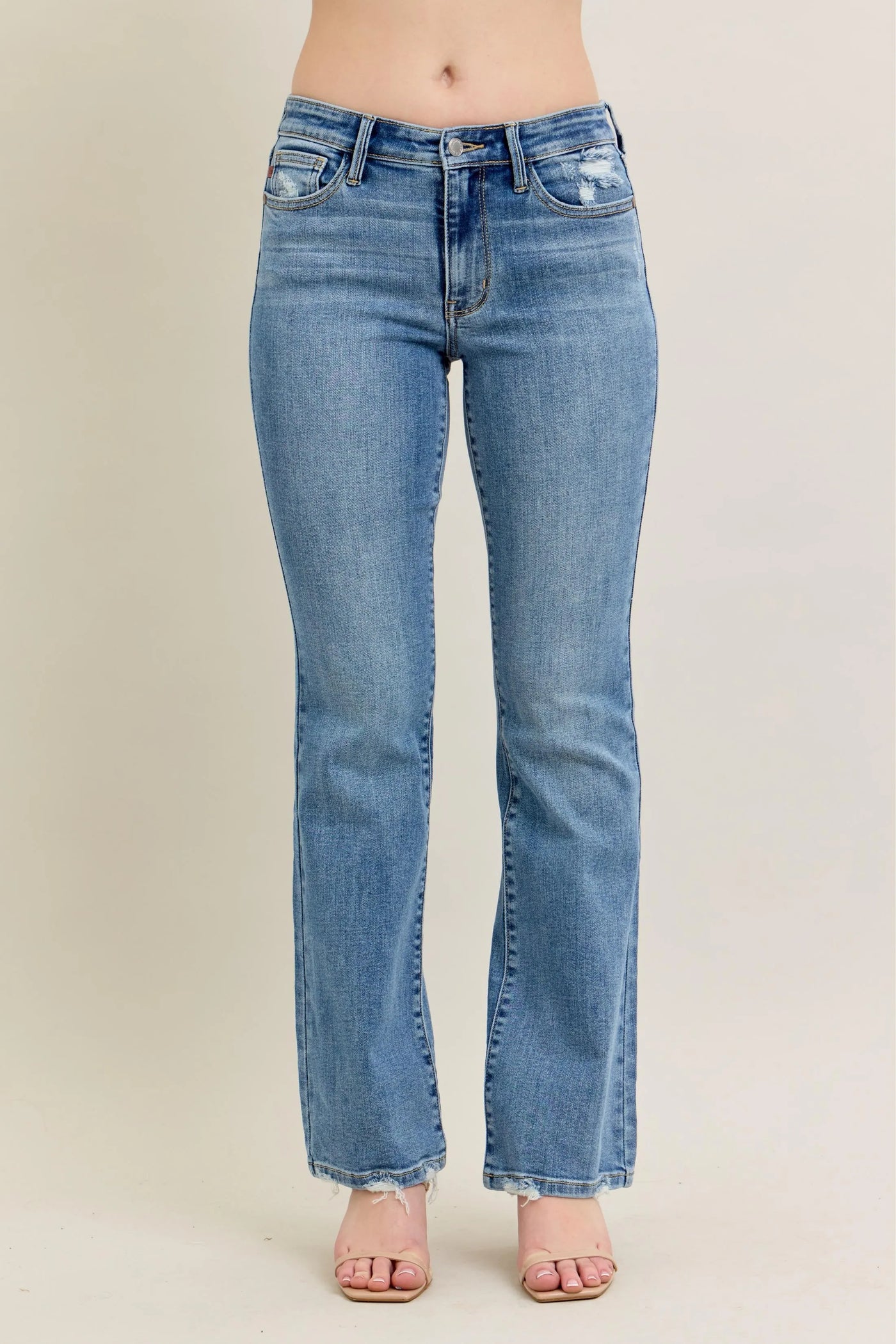Side view showcasing the fit of Judy Blue Full Size Mid Rise Wash Destroy Hem Bootcut Jeans Plus Size.