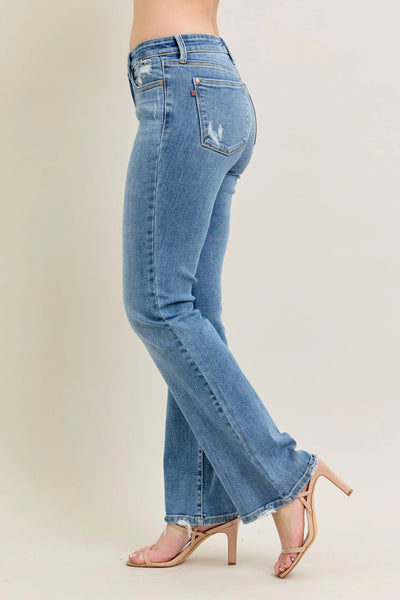 Close-up of the front detailing of Judy Blue Full Size Mid Rise Wash Destroy Hem Bootcut Jeans Plus Size.