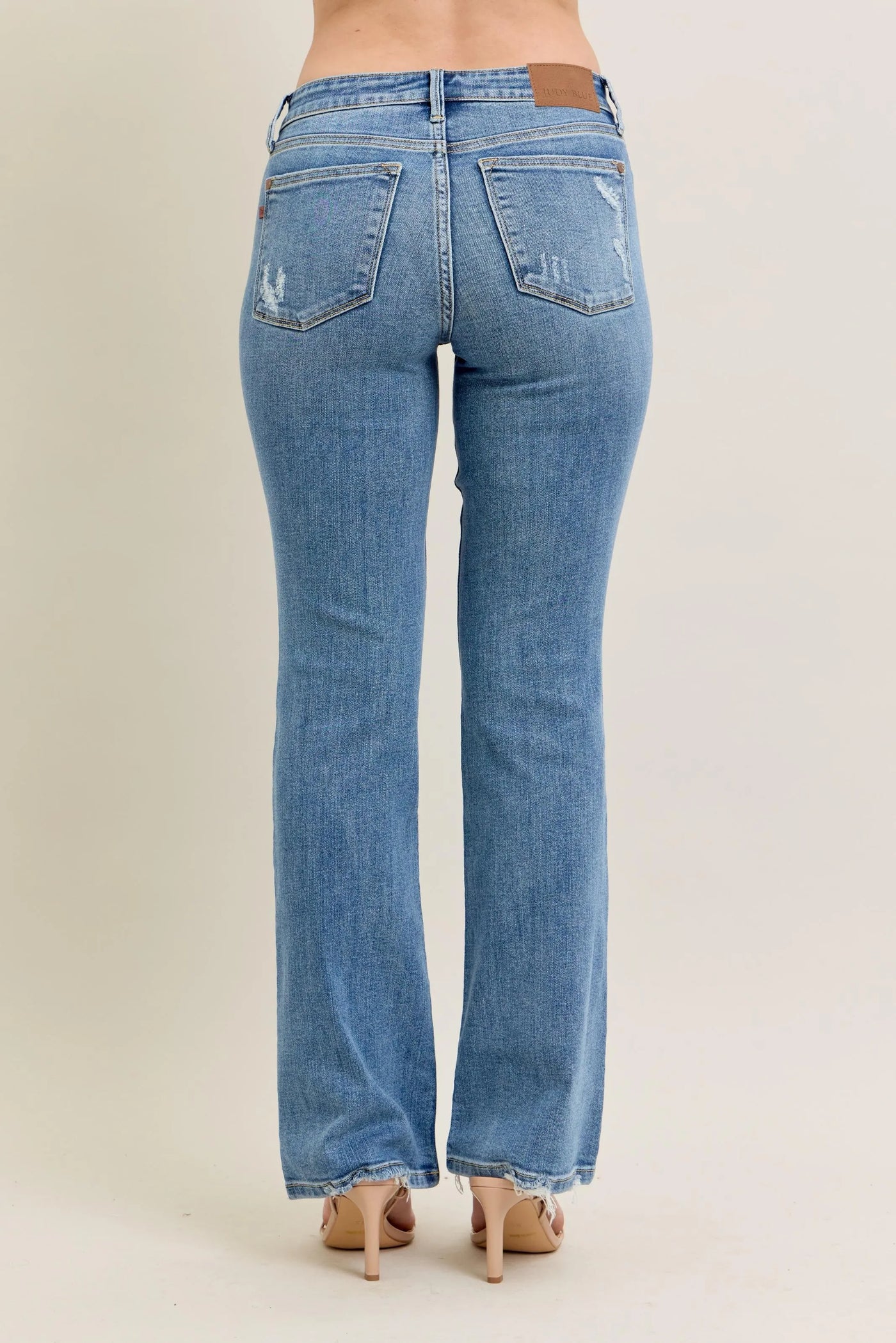 Close-up of the back detailing of Judy Blue Full Size Mid Rise Wash Destroy Hem Bootcut Jeans Plus Size.