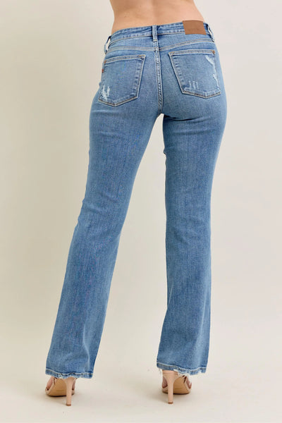Close-up side view emphasizing the bootcut flare of Judy Blue Full Size Mid Rise Wash Destroy Hem Bootcut Jeans Plus Size.