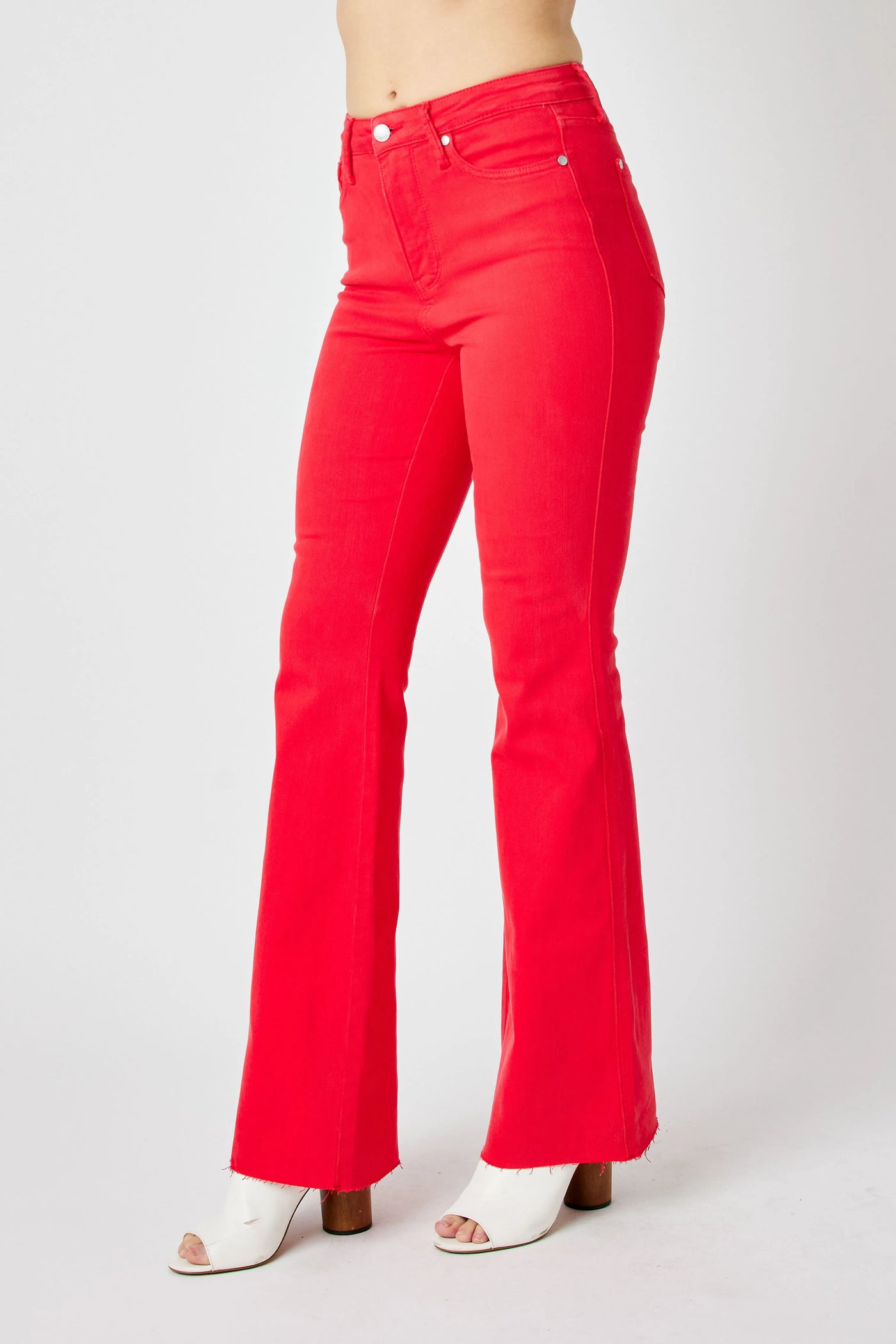 Close-up of the front detailing of Judy Blue Full Size High-Waisted Tummy Control Garment Dyed Flare Jeans in Red.