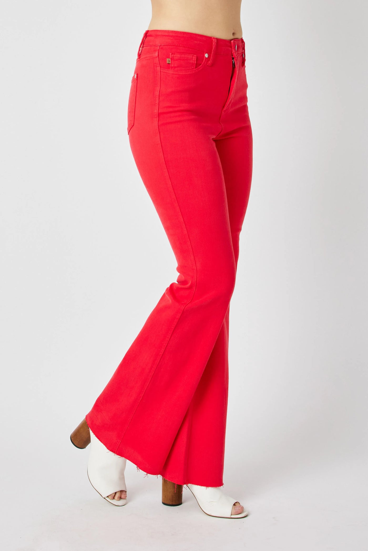 Close-up side view highlighting the flare of Judy Blue Full Size High-Waisted Tummy Control Garment Dyed Flare Jeans in Red.