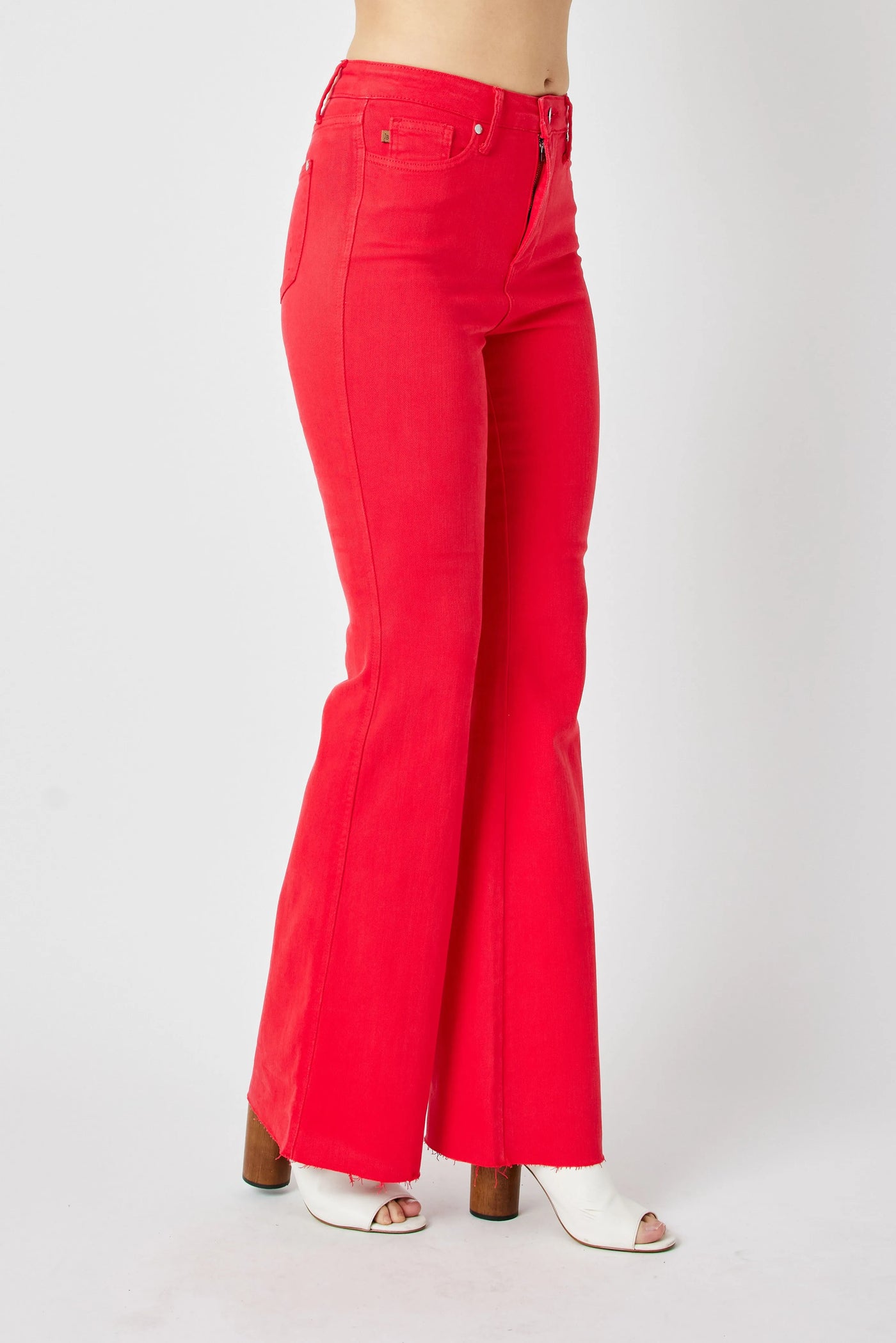 Model wearing Judy Blue Full Size High-Waisted Tummy Control Garment Dyed Flare Jeans in Red from the front.