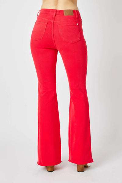 Side view of model showcasing Judy Blue Full Size High-Waisted Tummy Control Garment Dyed Flare Jeans in Red.