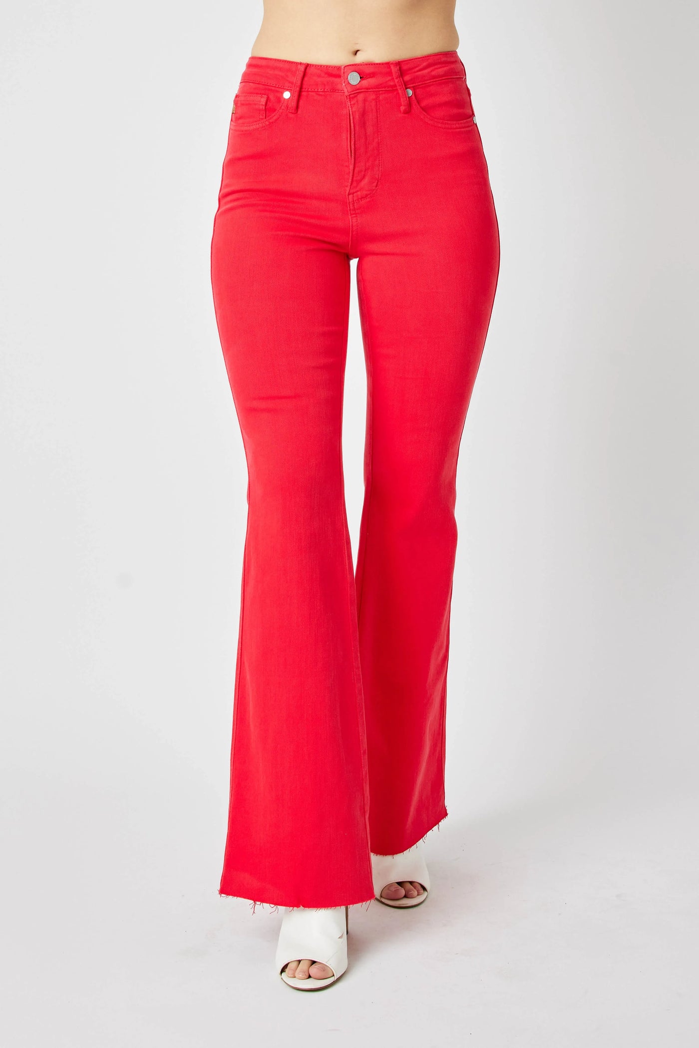Side profile of Judy Blue Full Size High-Waisted Tummy Control Garment Dyed Flare Jeans in Red.