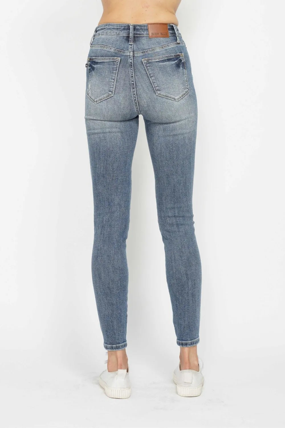 Side view showcasing the fit of Judy Blue Full Size Tummy Control Contrast Wash Skinny Jeans.