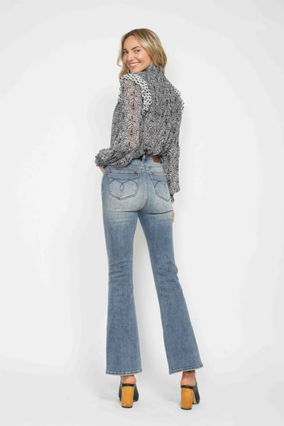 Back view of model wearing Judy Blue Full Size Tummy Control Back Embroidered Pocketed Bootcut Jeans Plus Size.