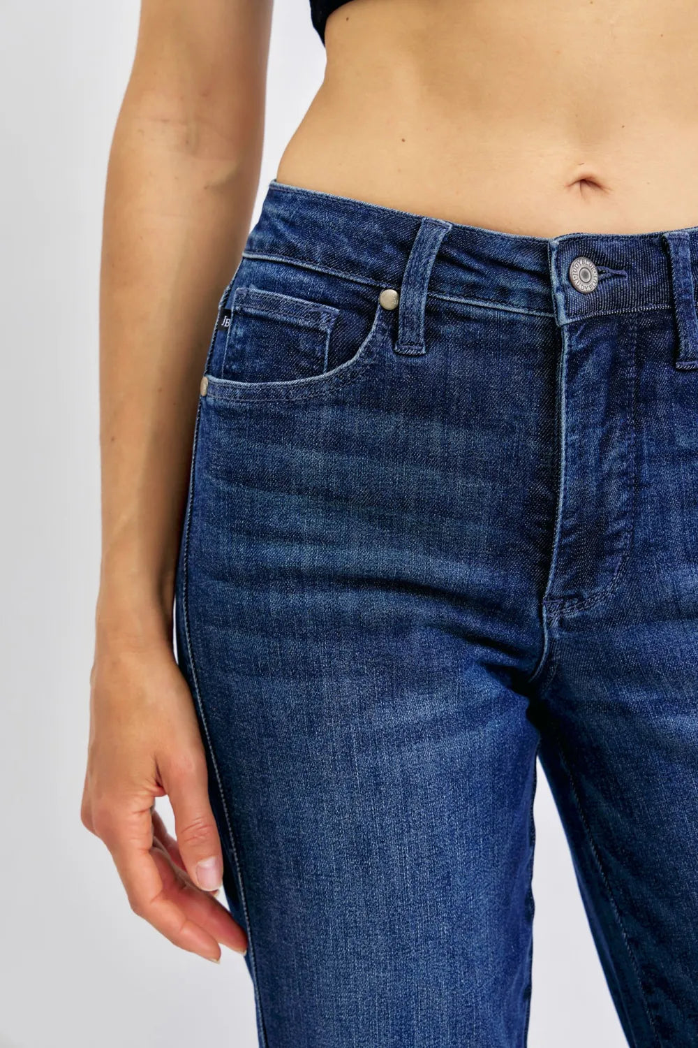 Angled front view of Judy Blue Full Size Tummy Control Straight Jeans Plus Size, showcasing the silhouette.