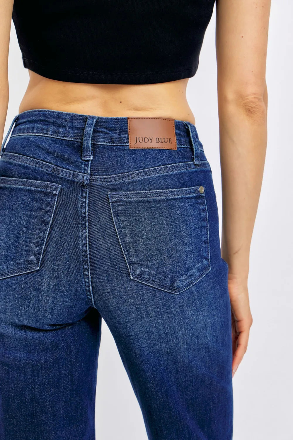 Angled back view of Judy Blue Full Size Tummy Control Straight Jeans Plus Size, highlighting the fit.