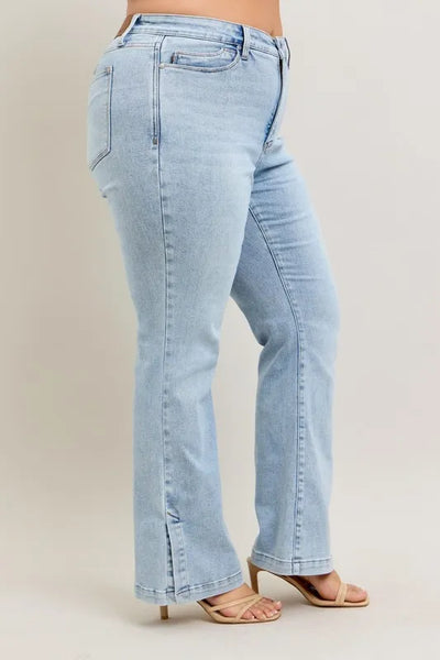 Back view of model wearing Judy Blue Full Size Tummy Control Vintage Wash Side Slit Slim Boot Jeans Plus Size.
